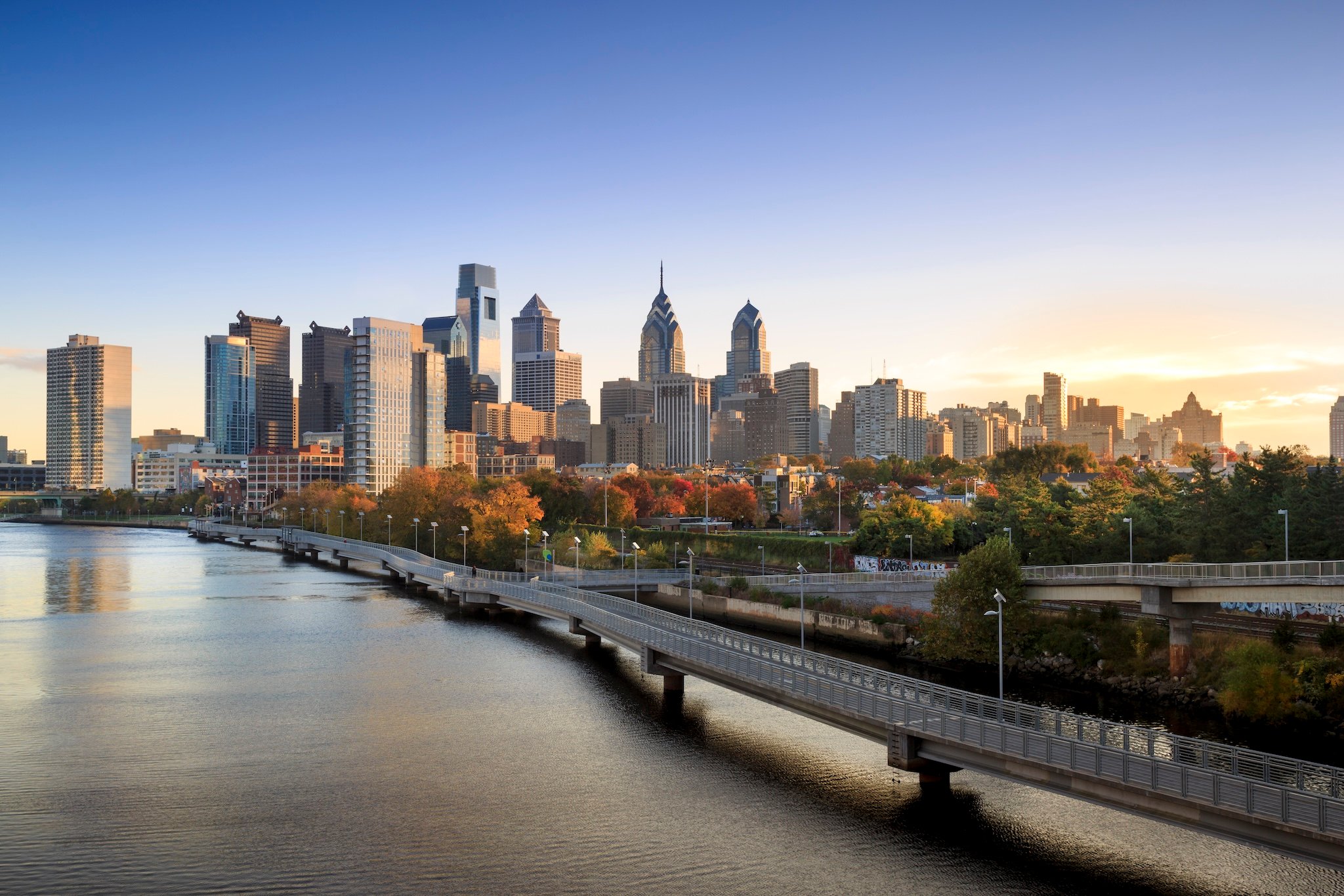 Skyline view of Philadelphia, Pennsylvania with river and bridge.