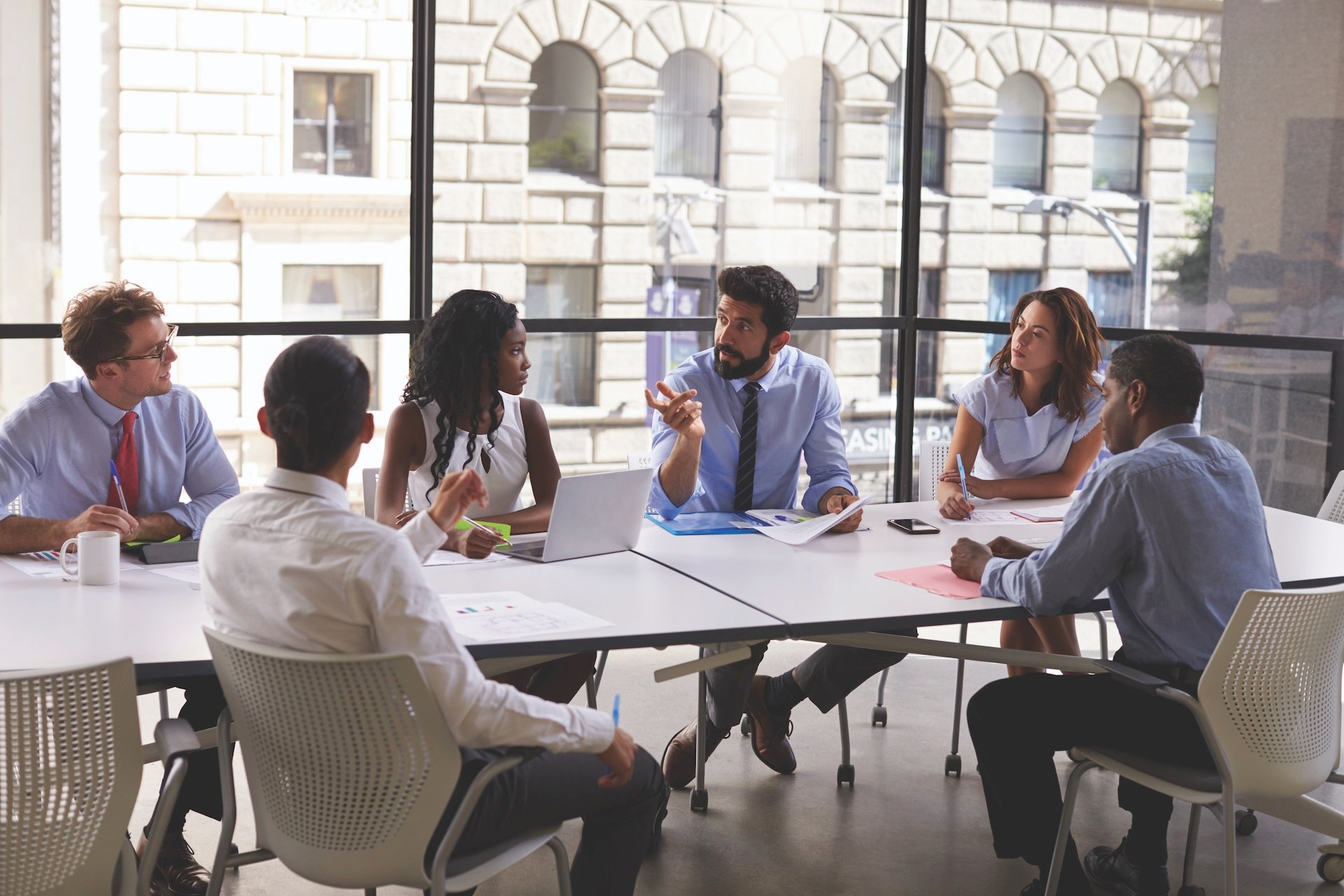 People around table in a meeting room.